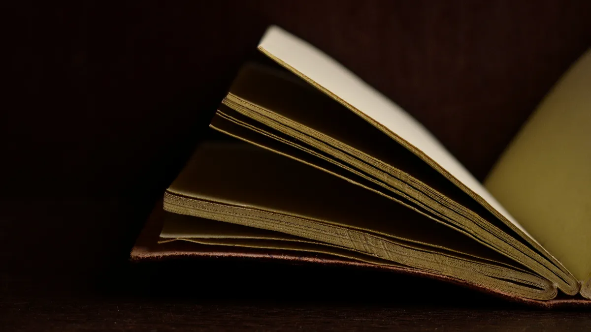 Smyth-sewn hardcover opened flat, showing the sewn spine