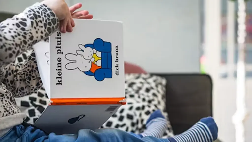 a baby holding baby board book