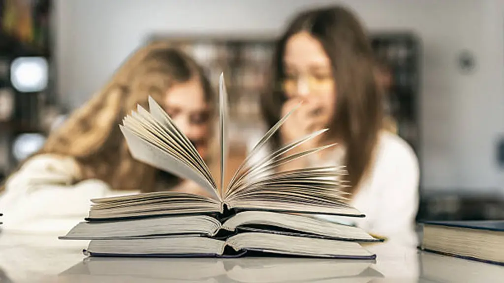 Children Reading and Studying Hardcover Story Books Together in a Library