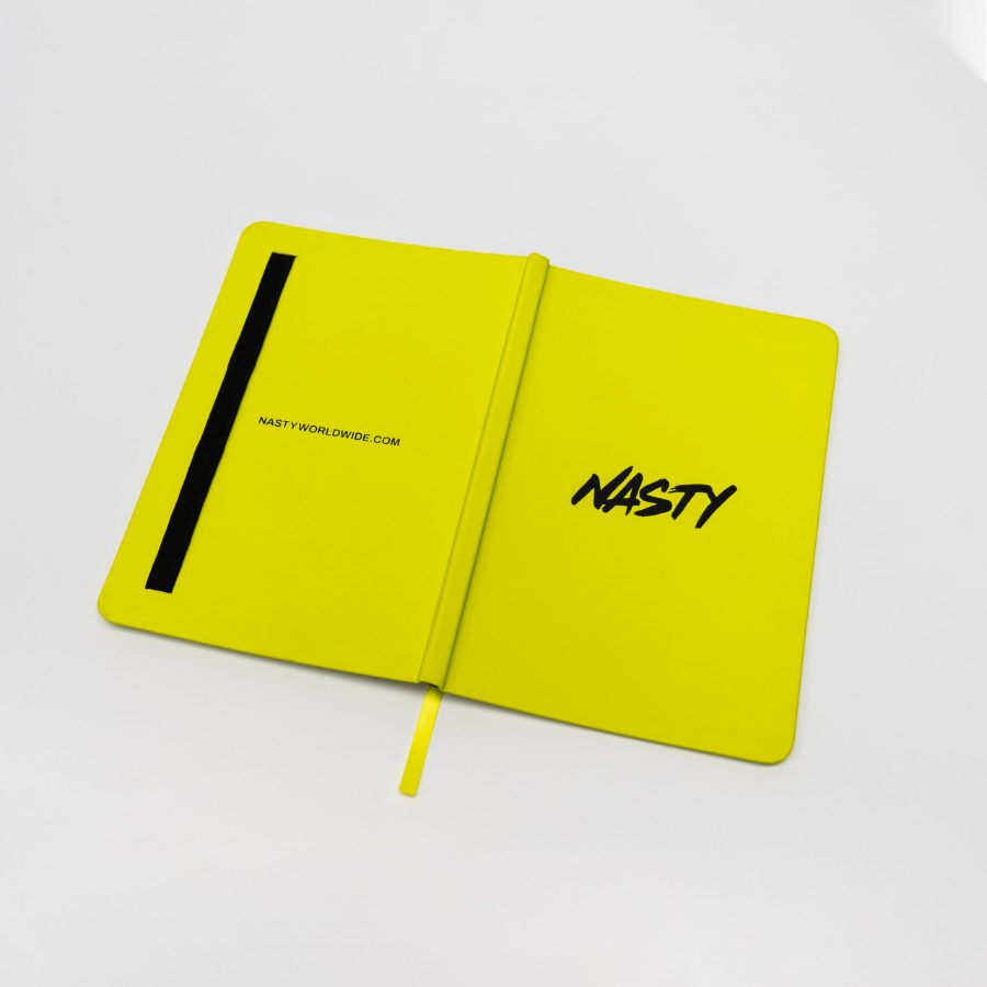 A yellow flexibound journal opened flat, showing a printed brand logo, an elastic pen loop on the inside back cover, and a matching ribbon marker
