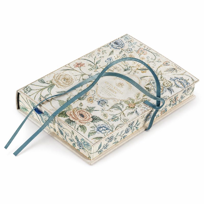 Two floral-printed journals inside a matching slipcase box with a teal ribbon carry handle